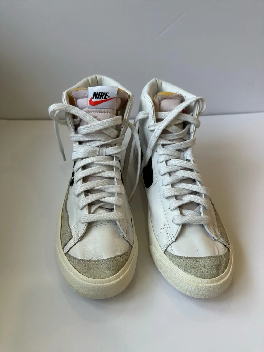 Nike White High-Top Sneakers with Black Swoosh